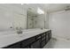 Bathroom featuring dual sinks, shower and a big mirror on the wall at 10807 W Morten Ave, Glendale, AZ 85307