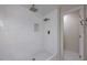 Bright bathroom with sleek tiled walk-in shower features both overhead and wall mounted shower heads at 10807 W Morten Ave, Glendale, AZ 85307