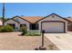 Charming home with desert landscaping, a two-car garage, and a welcoming entrance at 10807 W Morten Ave, Glendale, AZ 85307