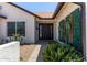 Inviting front entrance with stylish door, desert landscaping, and decorative wall accents at 10807 W Morten Ave, Glendale, AZ 85307