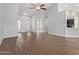 Open-concept living room with vaulted ceilings, stylish lighting, and seamless flow to the kitchen at 10807 W Morten Ave, Glendale, AZ 85307