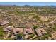 Wide aerial view of the estate nestled in a scenic desert landscape with natural rock formations and lush greenery at 11070 E Bent Tree Dr, Scottsdale, AZ 85262