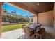 Beautiful covered back patio with seating, dining table, and stunning desert view at 11070 E Bent Tree Dr, Scottsdale, AZ 85262