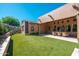 Spacious backyard with artificial grass and patio space, offering a low-maintenance and inviting outdoor area at 11070 E Bent Tree Dr, Scottsdale, AZ 85262