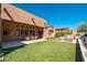 Expansive backyard with artificial grass, outdoor dining, and lounge area for perfect outdoor living at 11070 E Bent Tree Dr, Scottsdale, AZ 85262