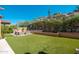 Beautiful backyard with lush artificial grass and custom seating area, ideal for relaxation and entertaining at 11070 E Bent Tree Dr, Scottsdale, AZ 85262