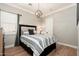 Bedroom with hardwood flooring, crown molding, stylish hanging light fixture, and large window at 11070 E Bent Tree Dr, Scottsdale, AZ 85262