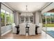 Bright dining room features a modern chandelier and scenic backyard views at 11070 E Bent Tree Dr, Scottsdale, AZ 85262