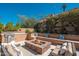 Charming backyard firepit with built-in seating and desert landscaping, creating a relaxing outdoor space at 11070 E Bent Tree Dr, Scottsdale, AZ 85262