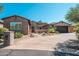 Inviting single-story brick and stucco home with desert landscaping and spacious driveway at 11070 E Bent Tree Dr, Scottsdale, AZ 85262