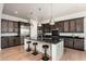 Modern kitchen features stainless steel appliances, a large island, and dark cabinetry at 11070 E Bent Tree Dr, Scottsdale, AZ 85262