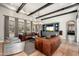 Bright living room with hardwood floors, exposed beams, and comfortable leather seating at 11070 E Bent Tree Dr, Scottsdale, AZ 85262