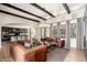 Spacious living room featuring exposed beams, hardwood floors, and an open floor plan at 11070 E Bent Tree Dr, Scottsdale, AZ 85262