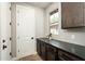 Butlers pantry features brick flooring, granite countertops, and white cabinets at 11070 E Bent Tree Dr, Scottsdale, AZ 85262