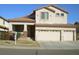 Two-story home with three-car garage, well-maintained lawn and desert landscaping at 11210 W Alvarado Rd, Avondale, AZ 85392