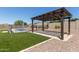 Inviting backyard featuring a pergola, artificial turf and a fenced pool at 12710 W Forest Pleasant Pl, Peoria, AZ 85383