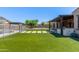 Enjoy outdoor living in this landscaped backyard with a covered patio, grill, and pool at 12710 W Forest Pleasant Pl, Peoria, AZ 85383