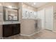 Bright bathroom with wood-style floors features a spacious, glass-enclosed shower with dual shower heads at 12710 W Forest Pleasant Pl, Peoria, AZ 85383