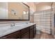 Bathroom with double vanity, shower with striped curtain, and modern fixtures at 12710 W Forest Pleasant Pl, Peoria, AZ 85383