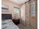 Cozy bedroom with wood-look floors and stylish barn door leading to the closet at 12710 W Forest Pleasant Pl, Peoria, AZ 85383