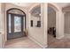 View of the foyer showing a decorative glass door, and an arched doorway to another room at 12710 W Forest Pleasant Pl, Peoria, AZ 85383