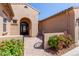 Close up view of the front entrance of the home featuring a gated entry and mature desert landscaping at 12710 W Forest Pleasant Pl, Peoria, AZ 85383