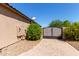Charming home exterior featuring a private gated entrance and paver driveway at 12710 W Forest Pleasant Pl, Peoria, AZ 85383