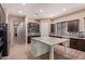 Contemporary kitchen featuring a granite island, stainless steel appliances, and tile backsplash at 12710 W Forest Pleasant Pl, Peoria, AZ 85383