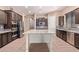 Bright kitchen features stainless appliances, dark cabinetry, gray backsplash, and a white center island at 12710 W Forest Pleasant Pl, Peoria, AZ 85383