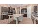Modern kitchen featuring a granite island, stainless steel appliances, and custom cabinetry at 12710 W Forest Pleasant Pl, Peoria, AZ 85383