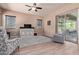 Comfortable living room offers neutral colors, wood floors, ceiling fan, and access to outdoor seating at 12710 W Forest Pleasant Pl, Peoria, AZ 85383