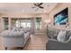 Open-concept living room featuring comfortable seating and a sliding glass door to the backyard at 12710 W Forest Pleasant Pl, Peoria, AZ 85383