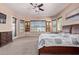 Spacious main bedroom with carpeted floors, ceiling fan, and large windows at 12710 W Forest Pleasant Pl, Peoria, AZ 85383