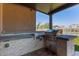 Outdoor kitchen with built-in grill and stone accents perfect for entertaining at 12710 W Forest Pleasant Pl, Peoria, AZ 85383