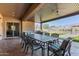 Covered patio with dining table, outdoor kitchen, and view of the pool at 12710 W Forest Pleasant Pl, Peoria, AZ 85383