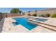 Private backyard pool and spa featuring stone accents and lush desert landscaping at 12710 W Forest Pleasant Pl, Peoria, AZ 85383