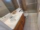 Bathroom featuring vanity with sink, toilet, and walk-in shower with glass doors and tile surround at 1414 W Monona Dr, Phoenix, AZ 85027