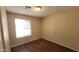 A light-filled bedroom features wood-look floors and a bright window at 1414 W Monona Dr, Phoenix, AZ 85027