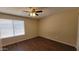 A comfortable bedroom features wood-look floors, a ceiling fan, and a window at 1414 W Monona Dr, Phoenix, AZ 85027