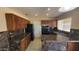A functional kitchen features a black refrigerator and warm wood cabinets at 1414 W Monona Dr, Phoenix, AZ 85027