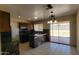 Modern kitchen featuring an island, dark countertops, tile floors, and sliding glass doors to yard at 1414 W Monona Dr, Phoenix, AZ 85027