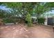 Backyard with mature shade tree, desert landscaping, and brick patio at 1441 E Hubbell St, Phoenix, AZ 85006