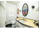 Bathroom features sleek black and white tiling, a toilet, and decorative mirror at 1441 E Hubbell St, Phoenix, AZ 85006