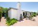 White single story home with unique chimney, tile roof, desert landscaping, and brick driveway at 1441 E Hubbell St, Phoenix, AZ 85006