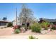 Charming home featuring desert landscaping, mature trees, flowering bushes, and white exterior at 1441 E Hubbell St, Phoenix, AZ 85006