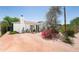 Charming home featuring brick driveway, desert landscaping, mature trees, and white exterior at 1441 E Hubbell St, Phoenix, AZ 85006