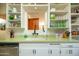 Kitchen sink features a decorative backsplash, bright countertop, and white cabinets at 1441 E Hubbell St, Phoenix, AZ 85006