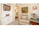 Sitting area with tiled floors, stylish chair, and archway looking into the living room at 1441 E Hubbell St, Phoenix, AZ 85006