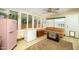 Cozy sun room with lots of light, vintage refrigerator, chest freezer, and comfortable sofa at 1441 E Hubbell St, Phoenix, AZ 85006