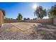 Spacious backyard featuring low-maintenance landscaping, framed in brick and gravel at 15611 W Cameron Dr, Surprise, AZ 85379